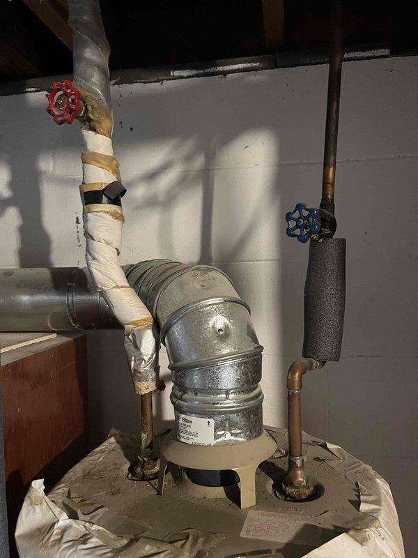 Performed annual heating tune-up on aging system with no humidifier. Inspected and documented condition of electrical connections and water heater installation including vent pipe and valve configuration. System is operational with maintenance contract valid through 2025.