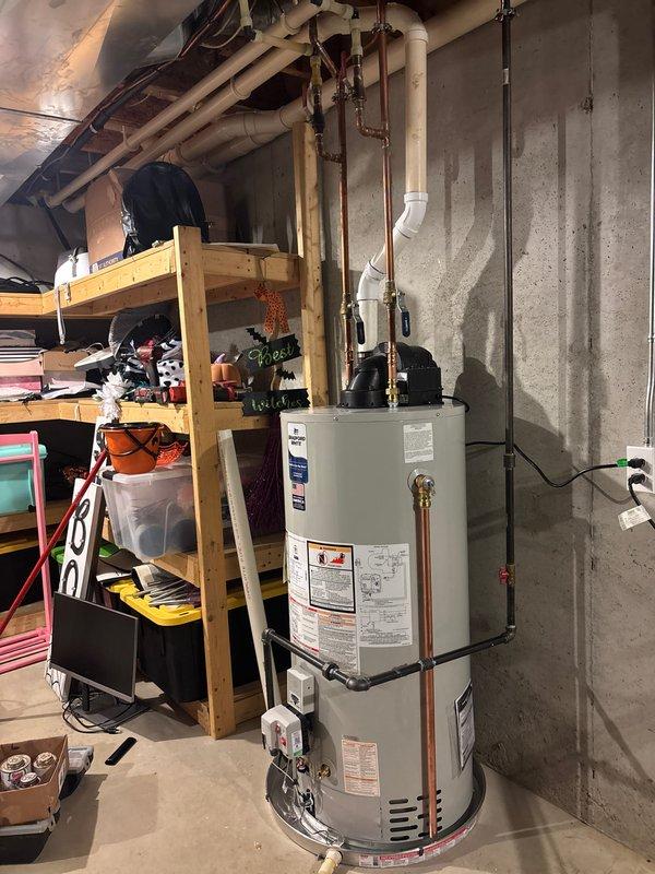 Successfully installed a new 50-gallon natural gas water heater with 10-year warranty in basement utility room. Connected unit to existing copper water lines and PVC ventilation system, ensuring proper placement on concrete floor. Completed all necessary plumbing connections and verified system operation before finalizing installation.