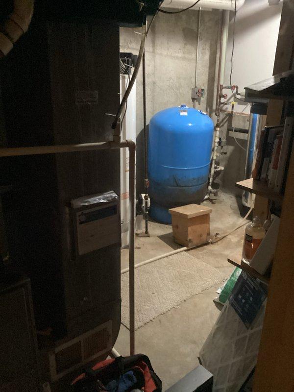 Completed annual heating maintenance on 17-year-old Ruud furnace system (last maintenance 2019). System inspection revealed no humidifier present. Documented existing plumbing infrastructure and pressure tank condition with photos. System is now operating within specifications after tune-up service.