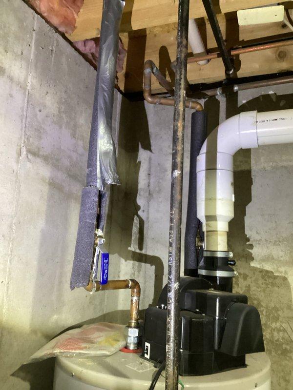 Completed annual heating maintenance on 17-year-old Ruud furnace system (last maintenance 2019). System inspection revealed no humidifier present. Documented existing plumbing infrastructure and pressure tank condition with photos. System is now operating within specifications after tune-up service.