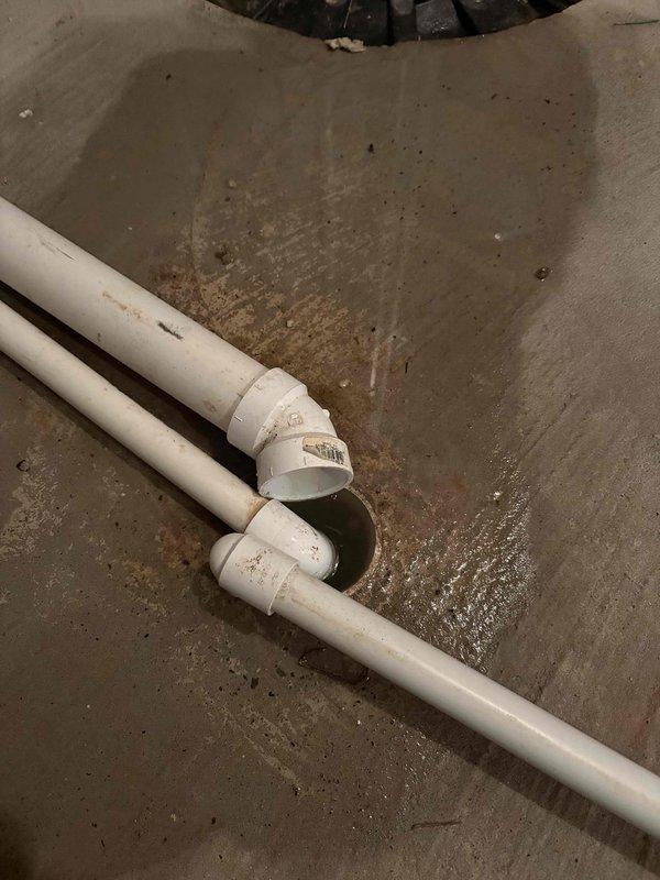 Performed annual heating maintenance on two furnace systems: 11-year-old Bryant and 2-year-old Amana units. Inspected associated humidifiers and documented condition of PVC drainage system in utility area, noting some moisture around pipe joints. Both systems functioning properly after service.