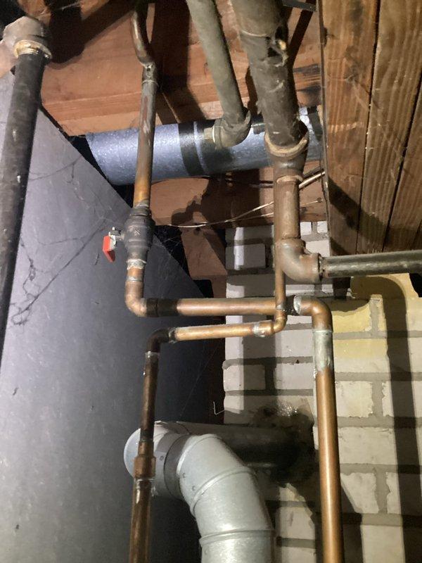 Performed water heater replacement estimate for CWOW. Inspected existing Richmond 5-gallon unit showing signs of age. Documented copper supply lines, nearby PVC drainage, and current installation configuration in basement utility area. Photos taken of existing plumbing network and water heater to support estimate preparation.