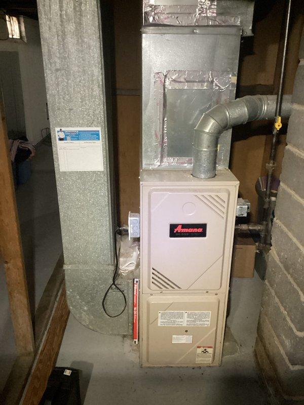 Performed annual heating tune-up on a 21-year-old Amana furnace system. Inspected ductwork connections and ventilation components, confirming proper seals on metal joints. No humidifier present on system; furnace is functioning within normal parameters with maintenance completed according to manufacturer specifications.