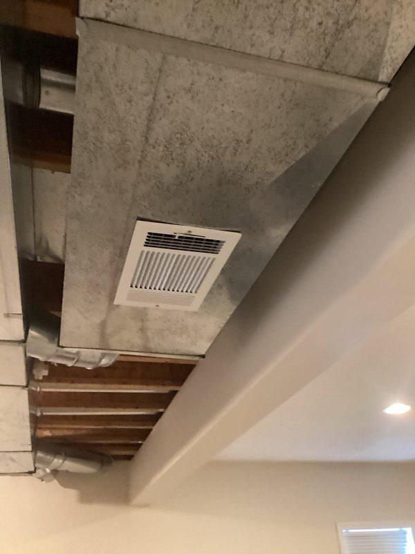 Performed annual furnace tune-up on customer's heating system under Energy Wise program contract CM:2025. Inspected ceiling vents and ductwork in unfinished basement area, noting proper installation of exhaust fan. System functioning normally with no humidity issues observed.