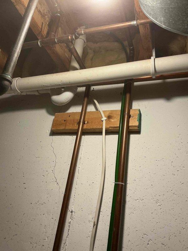 Conducted estimate for water softener installation in 25-year-old home with existing plumbing infrastructure. Assessed current setup including copper supply lines, water heater connections, and available utility space in basement area. Documented existing conditions with photos to provide accurate system specifications for replacement of aging water conditioning equipment.