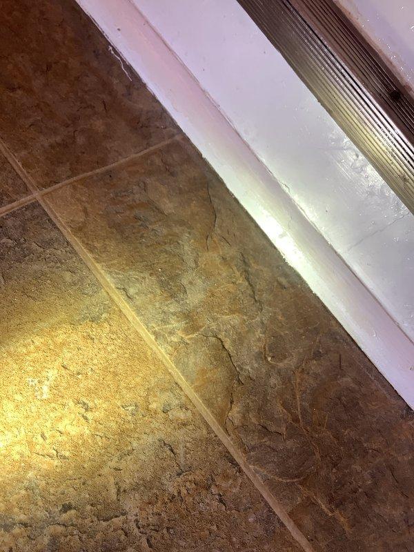 Responded to a recurring leak from second floor bathroom shower causing water damage to main floor ceiling. Inspection revealed inadequate waterproofing at the floor-to-wall junction in the shower area. Performed repair by removing damaged materials, installing proper waterproofing membrane, and sealing all joints to prevent future water intrusion through the subfloor structure.