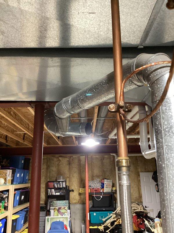 Performed annual heating maintenance service on EnergiAir furnace (model WT 06-2035) with no humidifier present. Inspected ductwork and connections in basement area, noting good condition of the galvanized metal pipe system with no visible issues. Examined copper plumbing connections near HVAC system and verified proper installation with no signs of leaks or corrosion.