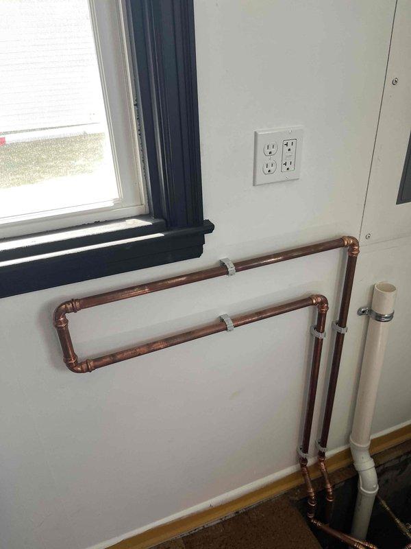 Successfully installed new electric water heater according to quote specifications. Completed tie-in of new 2" standpipe and installed waterline loop for water softener system. All copper and PVC piping properly secured to wall with appropriate fasteners, and electrical connections properly housed in junction box.