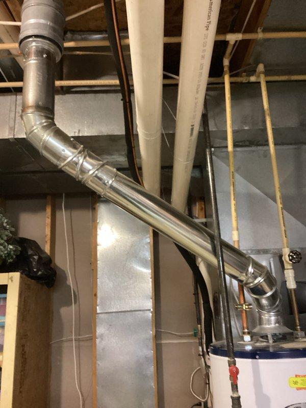 Conducted water heater estimate for a unit approximately 13 years old with temperature adjustment issues. Inspected existing installation in unfinished basement, noting connections to home's plumbing system including copper and PVC piping. Evaluated adjacent HVAC system with Honeywell components to ensure proper integration with any potential replacement water heater.