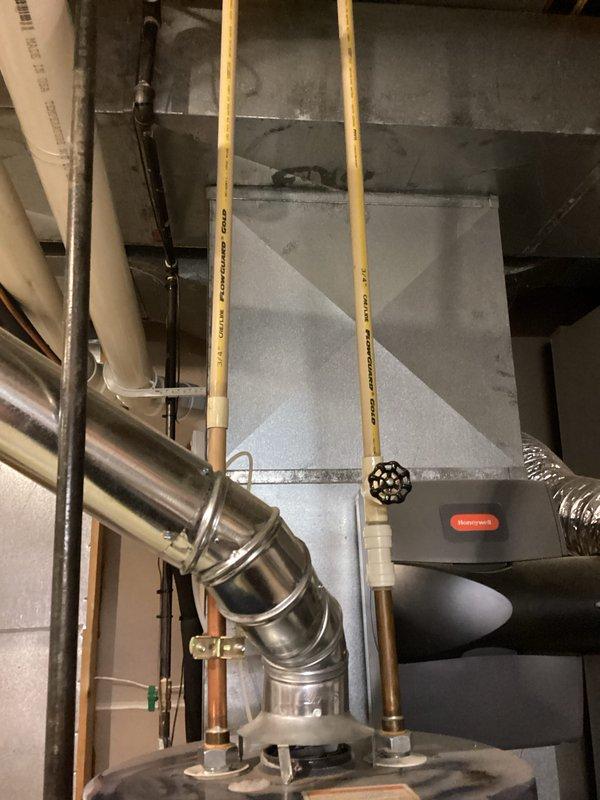 Conducted water heater estimate for a unit approximately 13 years old with temperature adjustment issues. Inspected existing installation in unfinished basement, noting connections to home's plumbing system including copper and PVC piping. Evaluated adjacent HVAC system with Honeywell components to ensure proper integration with any potential replacement water heater.