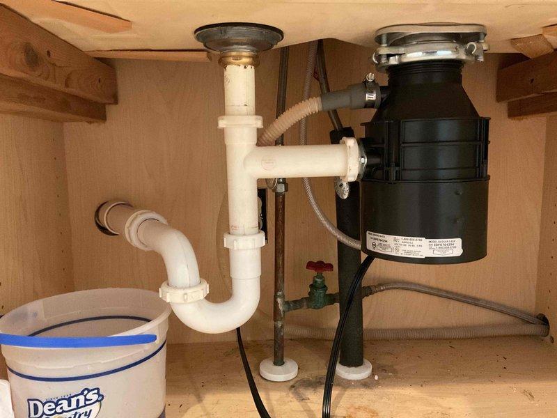 Responded to service call to replace garbage disposal unit. Successfully removed old black disposal and installed new unit, ensuring proper connections to existing PVC drain system and electrical supply. Tested operation and confirmed no leaks in the p-trap assembly and flexible drain hose connections.