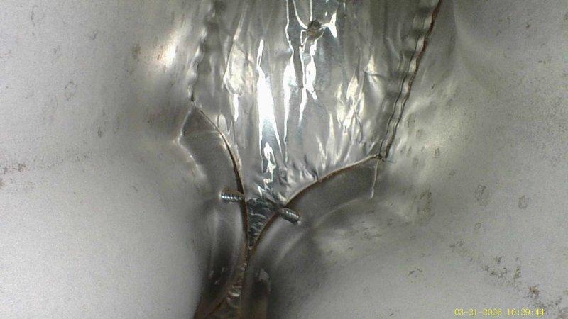 Responded to no-heat complaint on 13-year-old American Standard furnace. Diagnostic inspection revealed significant damage to heat exchanger with visible metal tearing and structural compromise. System requires replacement due to cracked heat exchanger posing safety concerns.