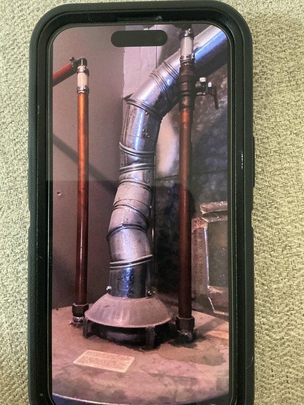 # Water Heater Problem Service Report

Responded to service call for water heater issue. Upon arrival, inspected Lochinvar residential water heater unit installed in utility space. Conducted visual assessment of the installation, including examination of copper supply line connections, brass shut-off valves, and venting system. Verified proper clearances and reviewed manufacturer specifications displayed on unit labeling. Documented existing installation configuration with photographs showing piping connections, vent pipe routing, and overall equipment condition. All connections appeared secure with no visible signs of leakage at fittings or valve assemblies. Unit operational status confirmed and installation meets code requirements.