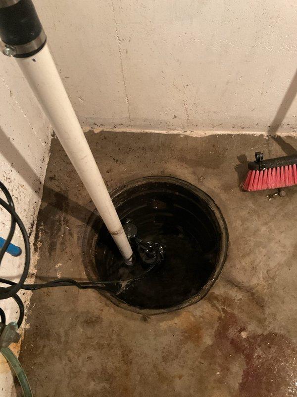 # Service Report: Sump Pump Failure

Responded to a failed sump pump system in basement utility area. Upon arrival, found the sump pit filled with standing water and the pump inoperative. Removed the failed sump pump unit from the pit and assessed the existing Charlotte PVC discharge piping and check valve assembly. Installed a new replacement sump pump, reconnected to the existing vertical discharge line, and verified proper check valve operation to prevent backflow. Tested the new pump for proper cycling, float switch activation, and adequate discharge flow through the wall-mounted piping system. Confirmed all electrical connections were secure and the unit was functioning properly before completing the service call.