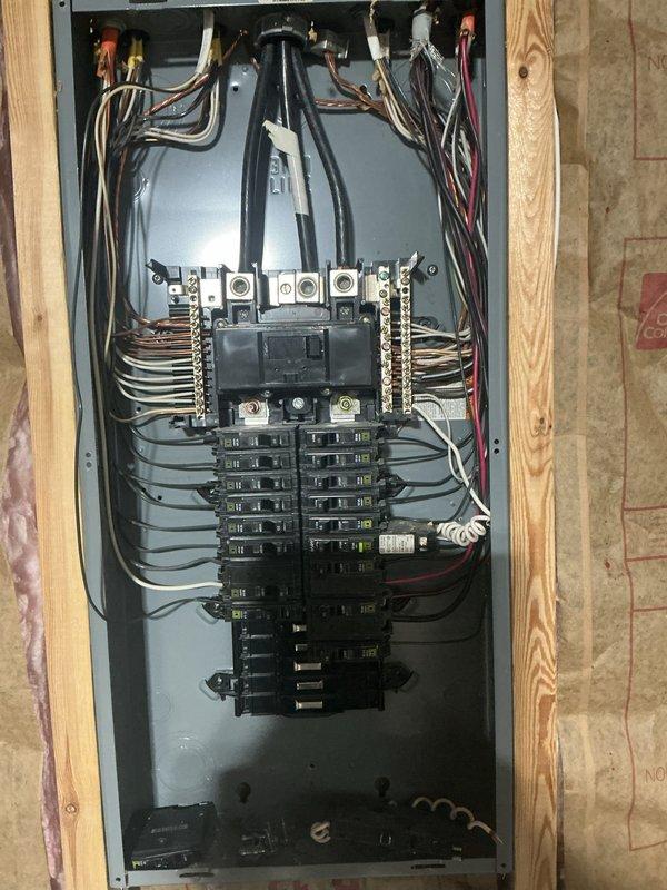 # Electrical Service Estimate Summary

Conducted on-site electrical assessment for breaker installation requirements at residential property. Evaluated existing electrical service configuration, including exterior meter assembly with multiple junction boxes and conduit connections mounted on vinyl siding. Inspected interior electrical panel installation featuring center-fed configuration with main disconnect contactor and dual vertical breaker arrays. Panel assessment revealed organized wire management with proper color-coded conductor routing and secure terminal connections. Documented current electrical infrastructure conditions including exposed wall framing with insulation, circuit breaker capacity, and main bus bar connections to provide comprehensive estimate for requested breaker installation work.