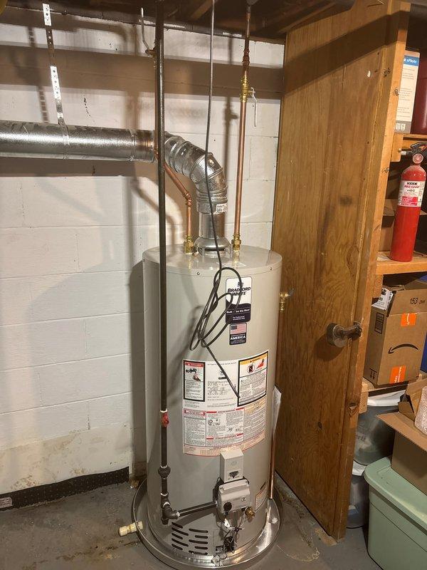 # Job Summary

Successfully completed installation of a 40-gallon natural gas Bradford White water heater (Model MS240S6N) with natural draft venting system, replacing existing unit in residential basement utility room.

# Work Performed

Removed and properly disposed of old water heater unit. Installed new 40-gallon Bradford White natural gas water heater with 40,000 BTU/HR input rating in basement mechanical room against concrete block wall. Connected copper supply and distribution piping with brass shutoff valves and fittings at top of unit. Installed flexible aluminum exhaust vent duct connecting from water heater top to existing horizontal ductwork, ensuring proper Category I natural draft venting configuration. Completed all electrical connections with appropriate wiring run along side of tank. Verified proper gas line connection to natural gas supply with correct manifold pressure settings. Tested all water connections for leaks and confirmed proper operation of temperature and 