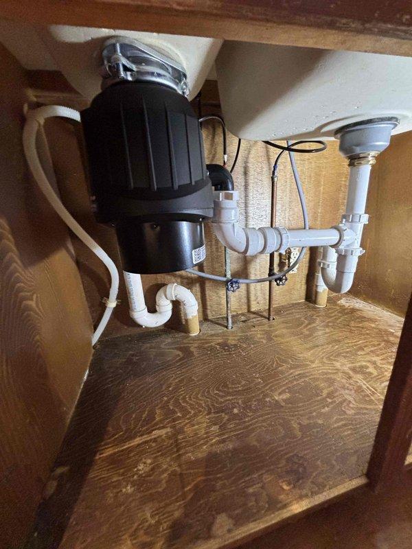 # Job Description

Completed QUOTR-quoted repair involving installation of customer-supplied garbage disposal unit and evaluation of kitchen faucet flow. Successfully installed the disposal unit under kitchen sink, connecting it to existing drain assembly with proper P-trap configuration using white PVC drainage piping. Verified secure mounting of disposal with all fasteners properly tightened and disposal motor assembly correctly positioned. Checked kitchen faucet flow rate and confirmed adequate water pressure and drainage performance. All plumbing connections tested for leaks and proper operation. System functioning as intended with no issues detected.