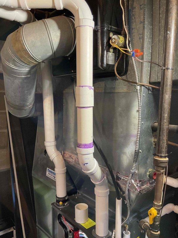 # Annual Heating Visit Summary

Completed annual heating system maintenance on 1-year-old EnergiAir furnace and 32-year-old Carrier equipment. Per customer request, inspected AC refrigerant charge during heating visit rather than performing full cooling system tune-up. System operates without humidifier. Documented equipment condition and drainage system with photos showing proper condensate management and typical water accumulation in drain pan.