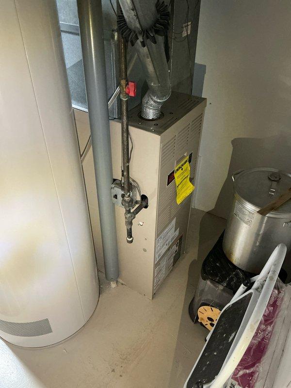 # Sales Estimate Summary

Conducted comprehensive sales estimate for complete HVAC system replacement in residential property with 30-year-old Goodman equipment. Evaluated existing upflow furnace, air conditioning system, and 50-gallon water heater for replacement options. Presented customer with two system configurations: hybrid mini-split heat pump system with water heater replacement, or traditional forced-air furnace and central AC system with new water heater installation.

# Detailed Service Description

Performed on-site evaluation and sales estimate for complete mechanical system replacement in residential basement utility room. Assessed existing 30-year-old Goodman furnace, central air conditioning system, and water heating equipment currently at end of serviceable life cycle.

Inspected current upflow furnace configuration with existing ductwork distribution system, noting metal supply ducts extending from unit top with flexible ducting connections and black corrugated drain 