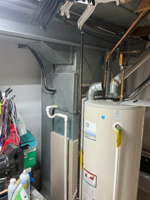 # Sales Estimate Summary

Conducted comprehensive sales estimate for complete HVAC system replacement in residential property with 30-year-old Goodman equipment. Evaluated existing upflow furnace, air conditioning system, and 50-gallon water heater for replacement options. Presented customer with two system configurations: hybrid mini-split heat pump system with water heater replacement, or traditional forced-air furnace and central AC system with new water heater installation.

# Detailed Service Description

Performed on-site evaluation and sales estimate for complete mechanical system replacement in residential basement utility room. Assessed existing 30-year-old Goodman furnace, central air conditioning system, and water heating equipment currently at end of serviceable life cycle.

Inspected current upflow furnace configuration with existing ductwork distribution system, noting metal supply ducts extending from unit top with flexible ducting connections and black corrugated drain 
