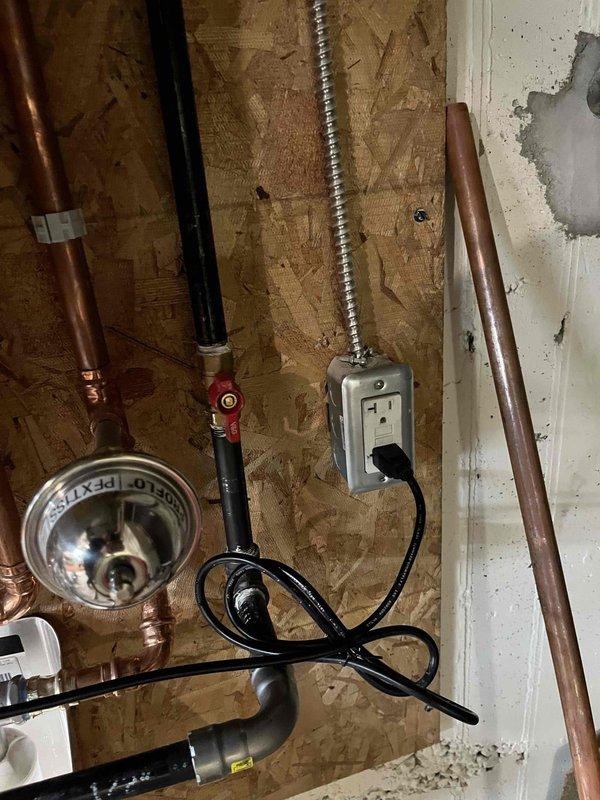 # Tankless Water Heater Repair Completion

Service technician returned from lunch break to complete repairs on tankless water heater unit. Internal components were accessed and serviced, including inspection and work on gas valve assembly, burner components, heat exchanger connections, and associated plumbing lines. Electrical connections and power supply to unit were verified, with proper grounding and outlet configuration confirmed. Copper supply lines with isolation valves and drain pan assembly were inspected and confirmed operational. All mechanical linkages, flexible gas connections, and safety components were tested and verified functioning properly before completing service and restoring unit to normal operation.