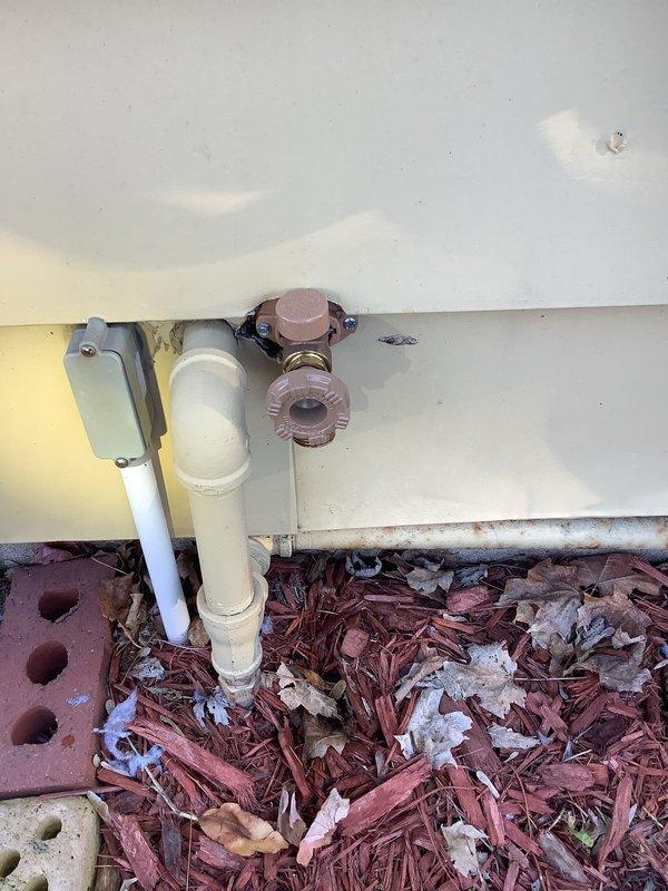 # Plumbing Leak Repair - Exterior Hose Spigot and Related Interior Leaks

Responded to a plumbing leak emergency at a 1955-built residence where an exterior hose spigot had been actively leaking for two days, with associated leaks manifesting inside the home. Upon arrival, performed comprehensive inspection of the exterior wall penetration point and traced the water supply line from the outside spigot through the wall cavity to identify all leak sources.

The exterior hose bib showed signs of valve stem failure and compromised packing, with visible water damage and staining on the white siding surrounding the copper pipe penetration point. The copper supply line exhibited corrosion consistent with the age of the home's original plumbing system. Water infiltration had traveled along the pipe pathway through the exterior wall, causing interior leak issues.

Shut off the main water supply to prevent further water damage. Removed the failed hose spigot assembly and inspected the copper sup