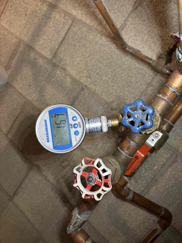 # Boiler Zone Valve Repair

Responded to service call for 28-year-old Utica boiler with heating zones not functioning properly. Upon arrival, confirmed that one of four zone valves was unresponsive to thermostat calls, resulting in inadequate heat distribution to affected areas while other zones operated normally.

Conducted systematic diagnosis of the boiler's multi-zone heating system. Inspected zone valve assembly and associated wiring at the manifold. Located problematic zone valve controlling basement heating area. Tested electrical connections and confirmed zone valve motor failure preventing valve actuator from opening when thermostat called for heat.

Examined the zone valve control board and relay system mounted in the joist space above the piping. Verified proper voltage supply to the malfunctioning zone. Determined the brass-bodied zone valve with yellow actuator motor had seized internally and required replacement.

Isolated the affected heating zone using existing shut-off