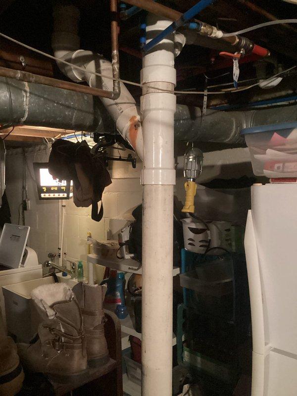 Completed drain repair beneath bathroom vanity involving replacement of deteriorated P-trap assembly and associated drain lines. Removed existing damaged PVC components, installed new P-trap with proper venting connections, and verified all connections for proper seal and drainage flow. Work area cleaned and tested to confirm no leaks and proper operation.