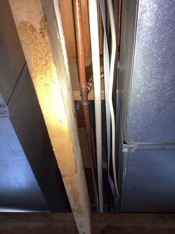 Technician responded to a miscellaneous plumbing repair request and assessed the installation site. Upon inspection, identified the necessary components and connections in the utility area, including copper piping, PVC lines, and an outlet box with brass fittings and valve assembly. Documented the existing conditions with photographs for reference. Work is currently on hold pending parts procurement, with technician scheduled to return to complete the installation once the required component arrives.