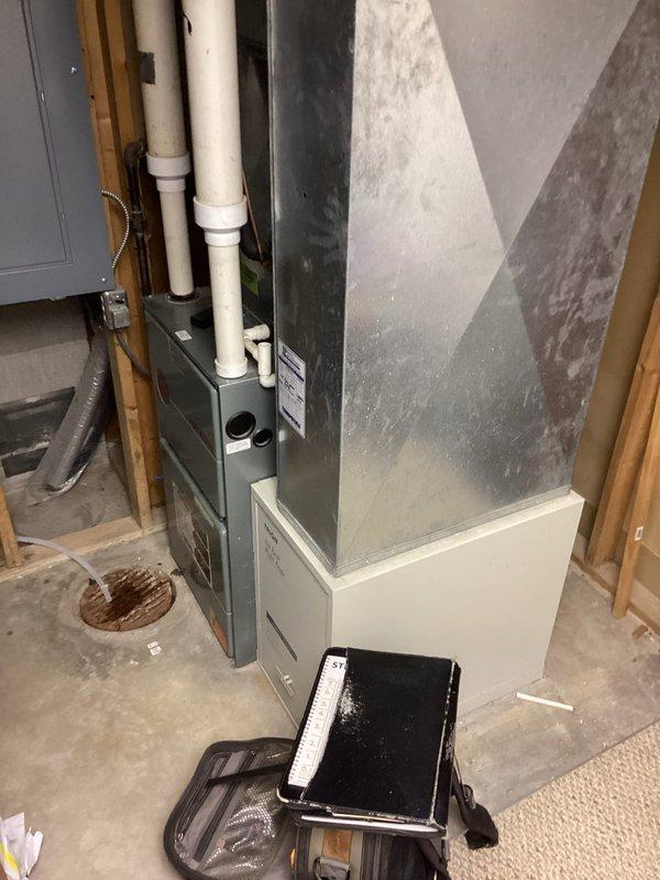 Responded to furnace making unusual noises during operation and blowing cold air before warm air. Inspected furnace unit in basement utility area, examined blower assembly, heat exchanger, and ductwork connections. Identified noise source related to blower motor operation and verified proper system cycling and airflow through supply plenum.