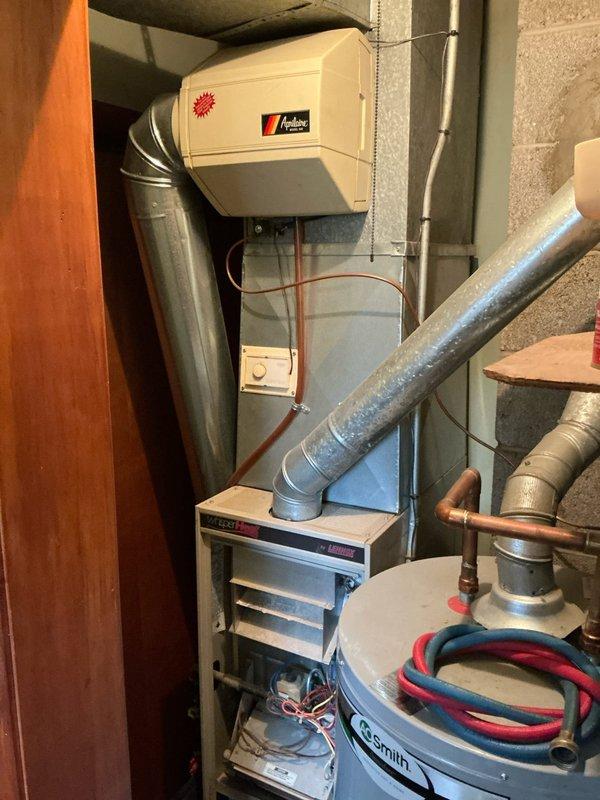 Conducted initial diagnostic assessment on non-operational furnace system in basement mechanical room. System evaluation was incomplete at time of service call, requiring technician to schedule return visit to continue comprehensive diagnosis and determine root cause of heating failure. Documentation photos captured of existing HVAC equipment configuration including furnace unit, Aprilaire humidifier, air handler, ductwork connections, and associated mechanical components for reference during follow-up service appointment.