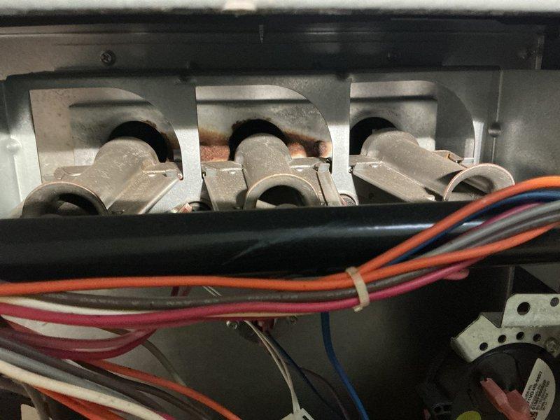 Completed annual heating maintenance on 13-year-old York furnace and humidifier system. Performed comprehensive tune-up including inspection of electrical connections at terminal bus bars, which showed moderate oxidation at contact points. Documented multi-phase wiring harness configuration and electrical panel condition. Conducted internal inspection of evaporator coil assembly using borescope camera to assess fin condition and verify proper airflow pathways. All components found operational with routine wear consistent with system age.