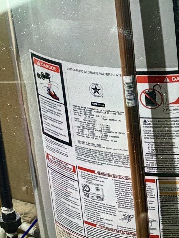 Completed full water heater replacement installation in residential utility space. Removed existing unit and installed new automatic storage water heater with proper venting system, including metal exhaust vent pipe routed from top of unit. Connected all copper supply lines, installed PEX flexible tubing connections, and mounted shut-off valves with blue handles on dedicated panel board for easy access and system control. Verified all plumbing connections for proper seal and tested unit operation to ensure safe and efficient functionality. Installation completed per manufacturer specifications with all required safety labels and compliance markings in place.
