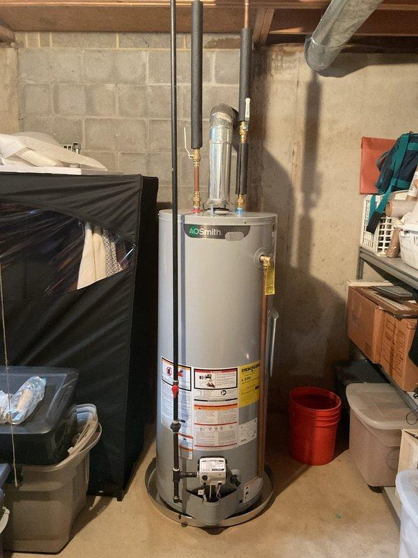 Completed installation of customer-supplied water heater with chimney liner venting system in basement utility area. Installed whole-home sediment filtration system with copper piping, brass shut-off valves, and pressure monitoring components mounted to basement wall with proper inlet/outlet configuration. Installed two tub/shower trim kits to complete bathroom fixture assemblies. All plumbing connections tested and verified operational with no leaks detected. Customer pre-paid for services, and installation was completed within one-day timeframe as scheduled.