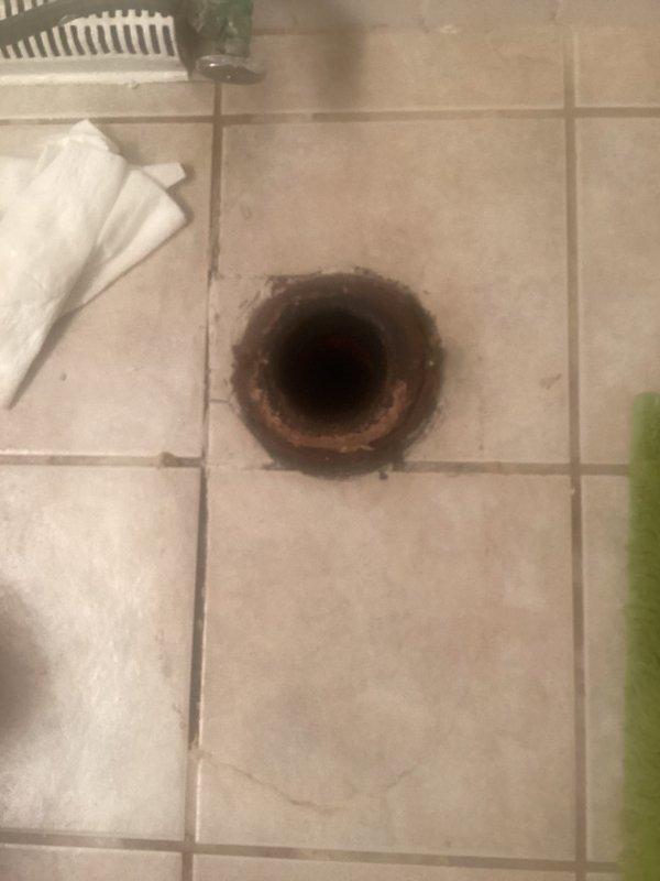 Responded to emergency plumbing call for kitchen sink leak. Upon arrival, inspected the affected area and identified water infiltration causing damage to surrounding flooring and subflooring. Traced leak source to kitchen sink drain assembly, disassembled components, and discovered compromised seal allowing water to escape beneath the fixture. Replaced faulty drain gasket and P-trap connections, tested system under full water pressure to confirm proper seal, and verified no additional leakage present. Documented pre-existing water damage to tile flooring and drain area for customer records.