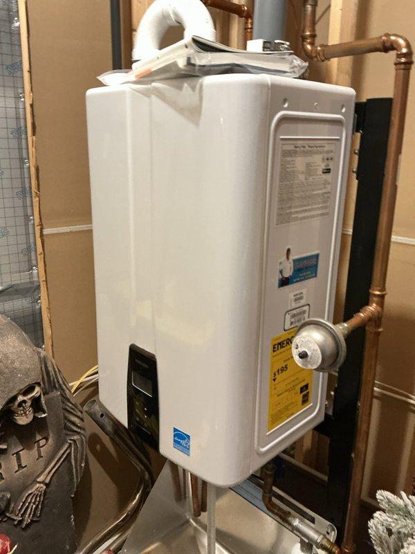 Responded to service call for 4-year-old Navien tankless water heater displaying error message. Upon arrival, performed diagnostic inspection of unit and reviewed error code on digital display panel. Inspected all electrical connections at junction box, verified proper wiring and secure wire nut connections. Examined water supply lines, gas connections, and PVC venting system for proper installation and function. Cleared error code, tested unit operation, and confirmed system returned to normal heating cycle with no fault codes present.