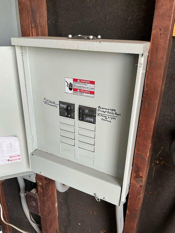 Provided estimate for replacement of existing 20-25 year old Bradford White natural gas tank water heater with new tankless system. Assessed current installation including copper supply lines, blue-handled shutoff valve, and venting configuration in basement utility area. Evaluated electrical requirements for tankless conversion, noting absence of existing electrical infrastructure at installation location and current breaker panel capacity limitations. Documented existing panel with multiple circuits serving furnace, microwave, and lighting loads in unfinished utility space with exposed stud framing. Discussed future electrical upgrade needs including panel amperage increase to accommodate tankless water heater demand, potential EV charger installation, and additional lighting projects. Scheduled follow-up appointment to address electrical scope assessment and provide comprehensive estimate for complete system conversion and electrical infrastructure improvements.