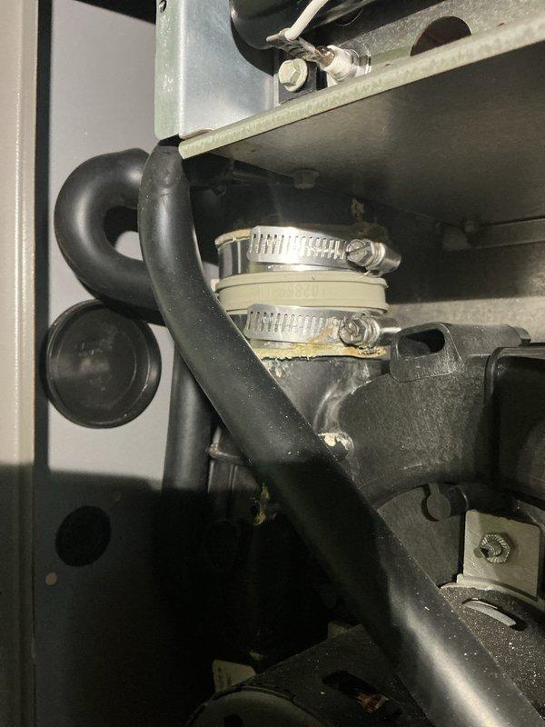 Responded to water leak emergency on 11-year-old furnace that was flooding the floor while continuing to operate. Inspected condensate drainage system and identified failed drain line connections causing water overflow. Replaced deteriorated hose clamps and reconnected drain lines with new stainless steel worm-drive clamps to secure proper drainage. Verified system operation with no further leaking and performed furnace tune-up maintenance as requested.