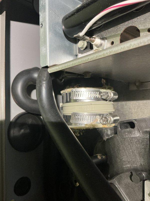 Responded to water leak emergency on 11-year-old furnace that was flooding the floor while continuing to operate. Inspected condensate drainage system and identified failed drain line connections causing water overflow. Replaced deteriorated hose clamps and reconnected drain lines with new stainless steel worm-drive clamps to secure proper drainage. Verified system operation with no further leaking and performed furnace tune-up maintenance as requested.