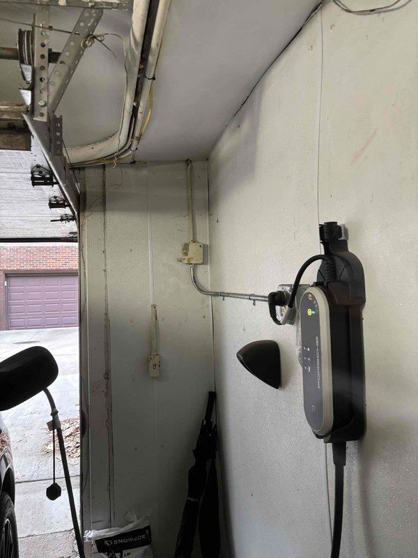 # Electrical Estimate Completed

Conducted site assessment for installation of exterior electrical outlets to support outdoor lighting in residential backyard patio area. Evaluated existing electrical infrastructure including garage-mounted EV charging station to determine optimal circuit routing and load capacity. Assessed installation locations along brick pillar structure and patio perimeter to accommodate decorative lamppost and additional outdoor lighting fixtures. Photographed current electrical setup and proposed installation areas for detailed estimate preparation.