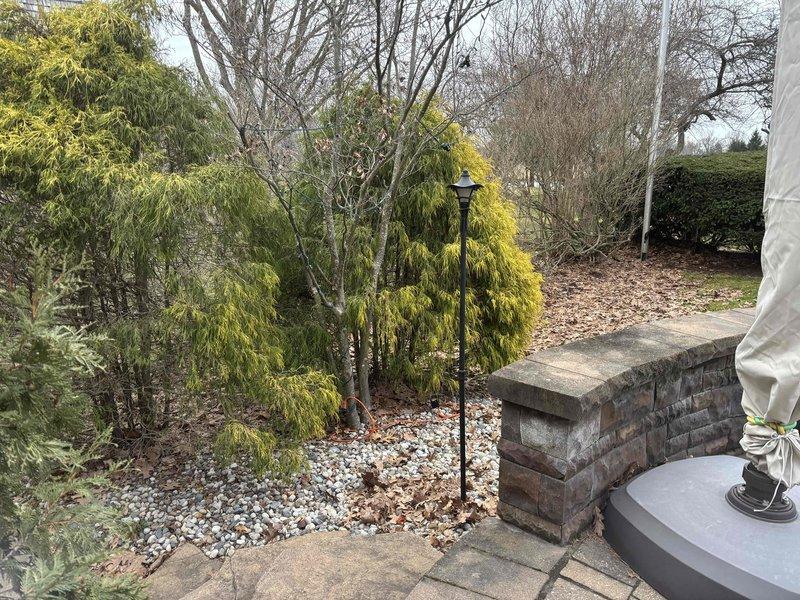 # Electrical Estimate Completed

Conducted site assessment for installation of exterior electrical outlets to support outdoor lighting in residential backyard patio area. Evaluated existing electrical infrastructure including garage-mounted EV charging station to determine optimal circuit routing and load capacity. Assessed installation locations along brick pillar structure and patio perimeter to accommodate decorative lamppost and additional outdoor lighting fixtures. Photographed current electrical setup and proposed installation areas for detailed estimate preparation.