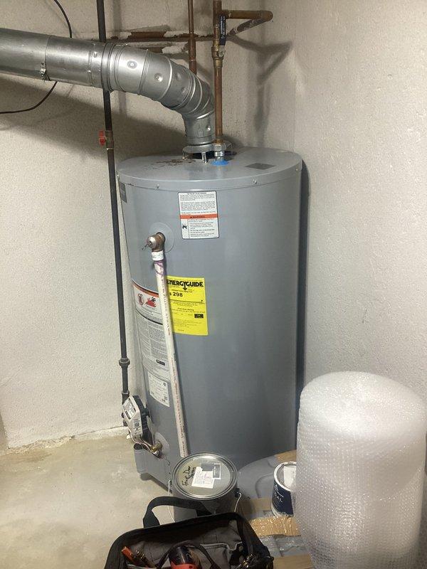 Reworked water heater venting system to improve pitch and ensure proper draft. Modified horizontal vent pipe routing and adjusted support brackets to achieve adequate upward slope for condensation drainage and optimal exhaust flow. Verified all connections are secure and compliant with manufacturer specifications.