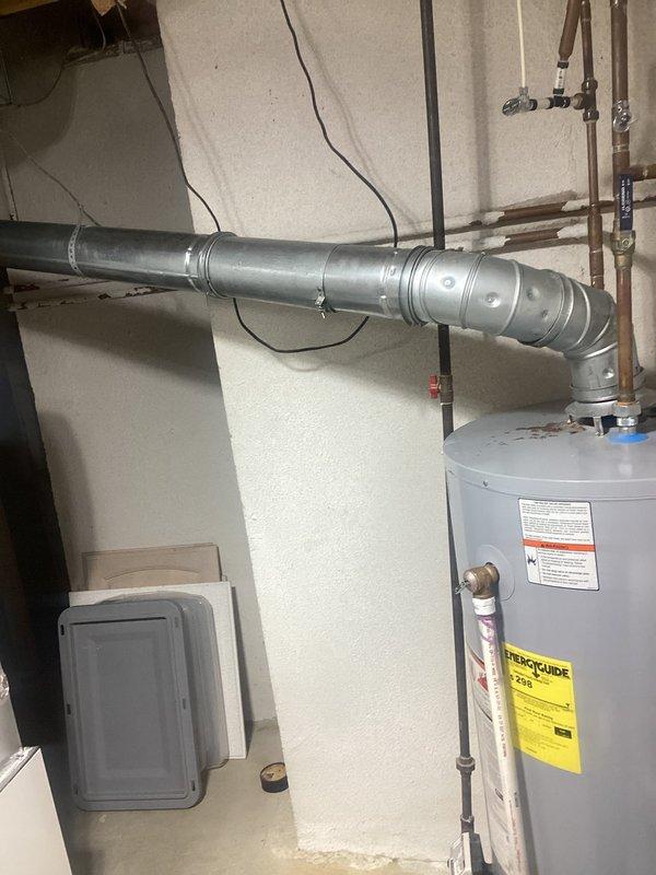 Reworked water heater venting system to improve pitch and ensure proper draft. Modified horizontal vent pipe routing and adjusted support brackets to achieve adequate upward slope for condensation drainage and optimal exhaust flow. Verified all connections are secure and compliant with manufacturer specifications.
