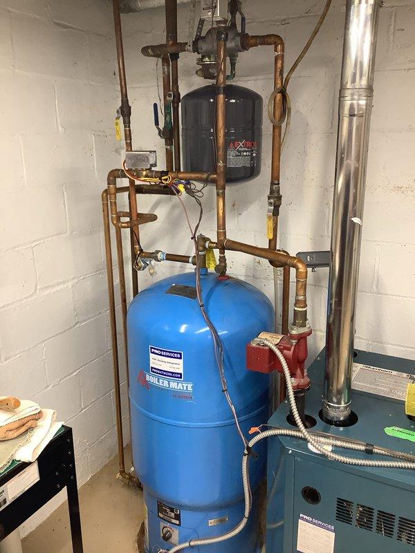 Conducted on-site evaluation of existing hydronic heating system to provide estimate for water conditioning equipment installation. Assessed current mechanical room configuration including EXTROL pressure tank, expansion tanks, copper piping network, and residential boiler unit. Documented existing plumbing infrastructure, valve locations, and available space for potential water softener or conditioning system placement. Photographed current equipment layout and piping connections to determine optimal integration points for water treatment equipment.