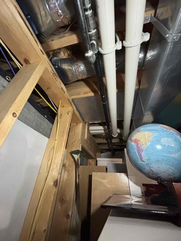 Responded to service call for 10-year-old water heater not heating as well as expected. Performed diagnostic inspection of water heating system in basement utility area, documenting equipment condition and installation configuration. Assessed HVAC equipment, associated piping systems including PVC and copper refrigerant lines, and overall mechanical room setup to identify potential issues affecting heating performance.