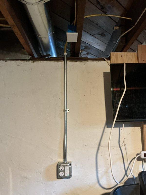 Completed three hours of general repairs in unfinished basement area, including electrical conduit work and outlet installation along beige wall surface. Organized workshop pegboard tool storage system with proper mounting and arrangement of power tools, hand tools, levels, screwdrivers, and wrenches for optimal accessibility.