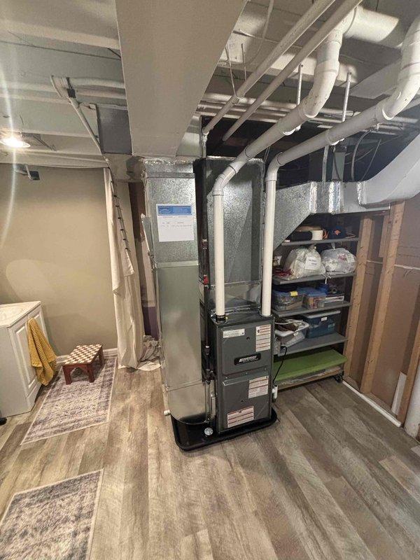 Completed full furnace replacement in basement utility area. Installed new vertical black furnace unit with proper PVC venting system, connected metallic supply and return ductwork with insulated wrapping, and ensured all manufacturer specifications were met. System tested and verified operational, with all connections secured and installation meeting code requirements.