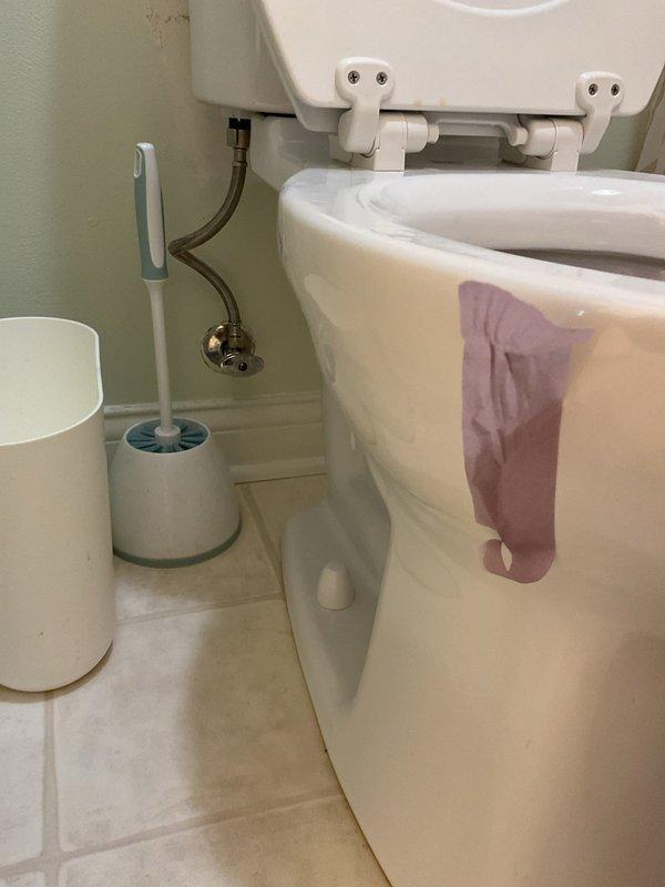 Responded to a plumbing leak investigation at a residential bathroom. Upon arrival, conducted a thorough inspection of the toilet and surrounding plumbing fixtures to identify the source of reported water leakage. Examined the water supply lines, tank connections, mounting hardware, and floor area around the toilet base for signs of moisture or active leaks. Documented conditions with photographs showing the toilet assembly, wall-mounted supply lines, and bathroom fixtures. The standard two-piece toilet with visible tank and bowl connections was assessed for proper sealing and potential leak points. Inspection complete.