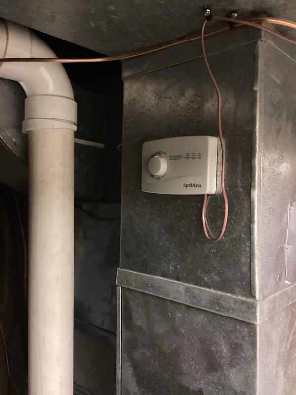 Completed installation of AprilAire whole-home humidifier system with automatic control integration into existing HVAC ductwork. Mounted humidifier control unit on supply plenum, connected water supply line, established electrical connections to furnace control board, and verified proper communication between humidifier controller and HVAC system for automated humidity management.