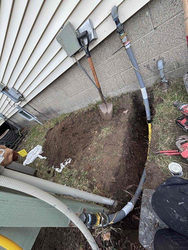 Completed gas line replacement project at residential property. Removed and replaced deteriorated gas piping system that exhibited severe corrosion, rust buildup, and mineral deposits throughout the existing infrastructure. Excavated exterior trench adjacent to foundation wall to access underground gas line routing. Installed new gas-rated piping from exterior meter connection point through foundation penetration to interior distribution manifold. Secured all new piping to foundation wall with proper strapping and support brackets per code requirements. Pressure tested completed gas line system to verify integrity of all connections and fittings. Backfilled exterior excavation and restored work area to original grade.